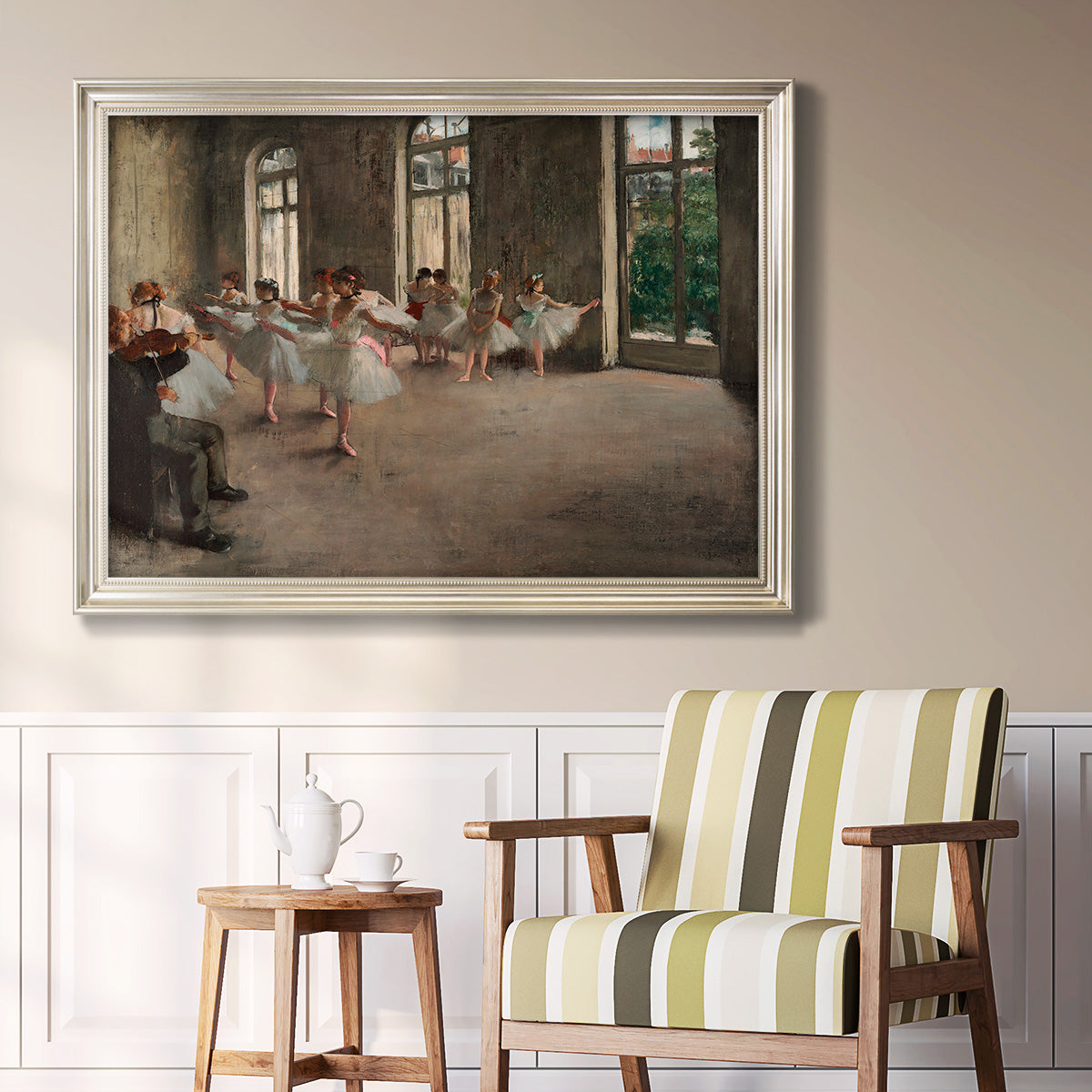 Early impressionist ballet rehearsal painting by Edgar Degas in an ornate champagne frame displayed in a light-toned interior setting.