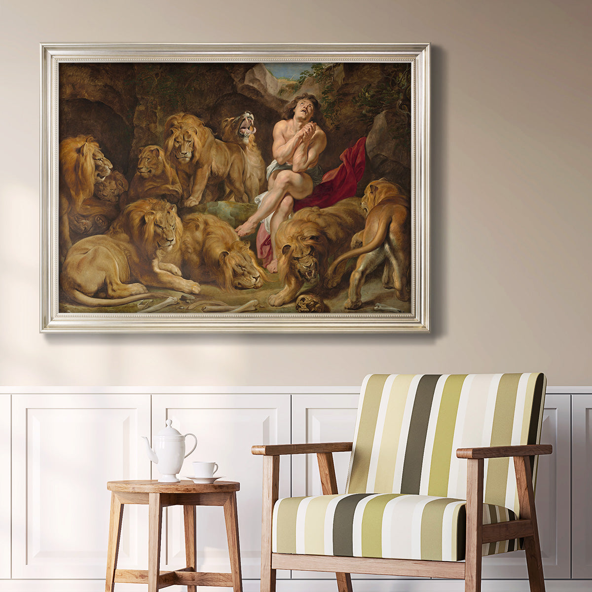 Dramatic biblical painting of Daniel with lions by Peter Paul Rubens in an ornate champagne frame displayed in a light-toned interior setting.