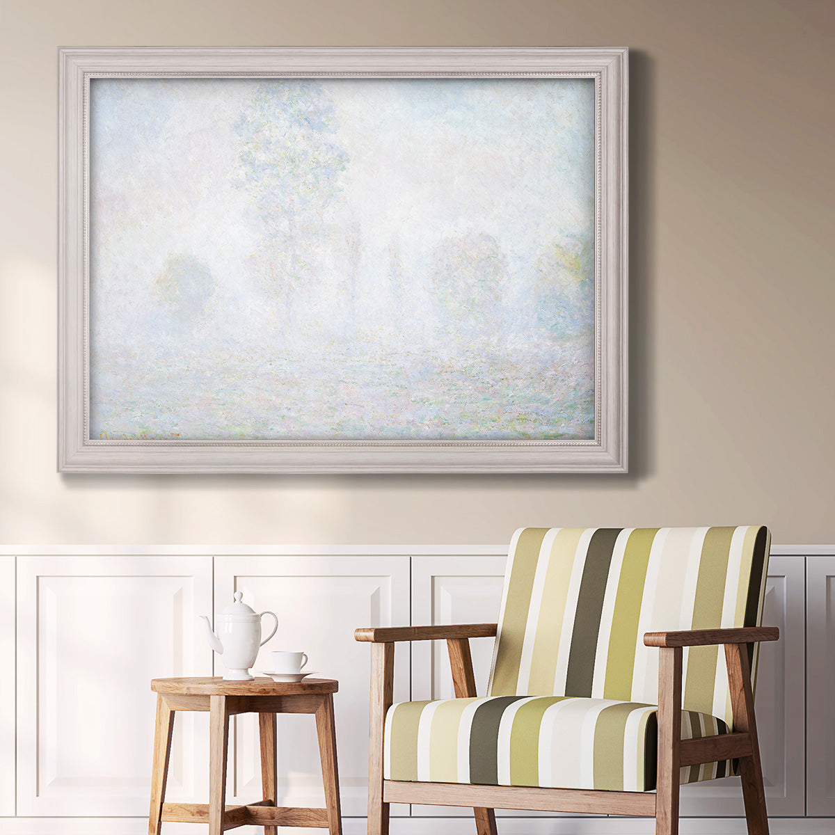 Impressionist atmospheric landscape in morning haze by Claude Monet in an ornate weathered white frame displayed in a light-toned interior setting.