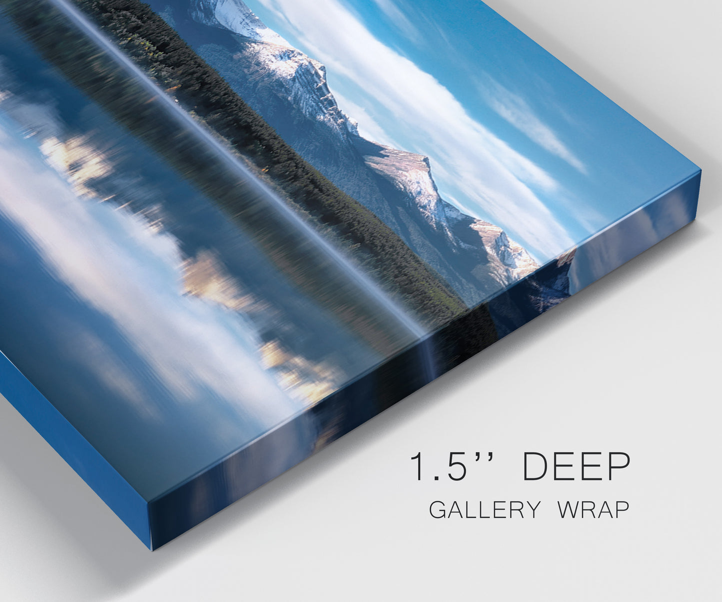 Close-up view of wrapped canvas corner featuring calm lake beneath mountains photograph.