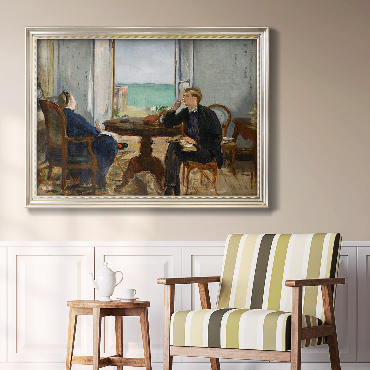 Impressionist interior scene by Édouard Manet in an ornate champagne frame displayed in a light-toned interior setting.