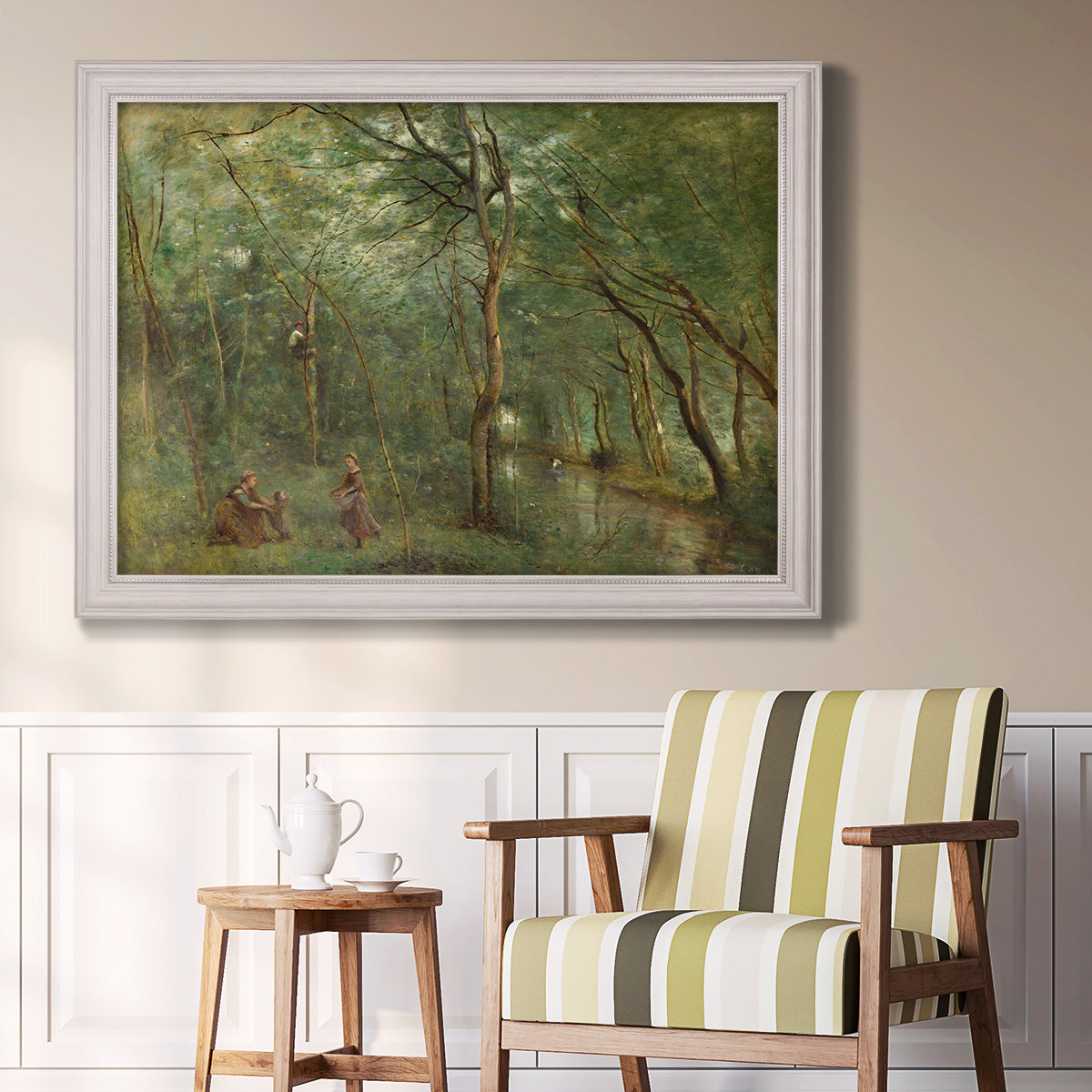 Traditional rural landscape scene with figures by Jean-Baptiste-Camille Corot in an ornate weathered white frame displayed in a light-toned interior setting.