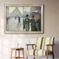 Impressionist urban street scene in the rain by Gustave Caillebotte in an ornate champagne frame displayed in a light-toned interior setting.
