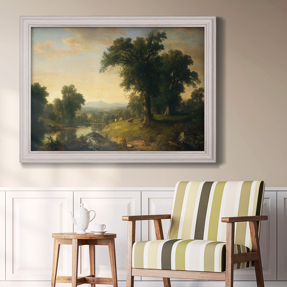 Traditional pastoral landscape painting by Asher Brown Durand in an ornate weathered white frame displayed in a light-toned interior setting.