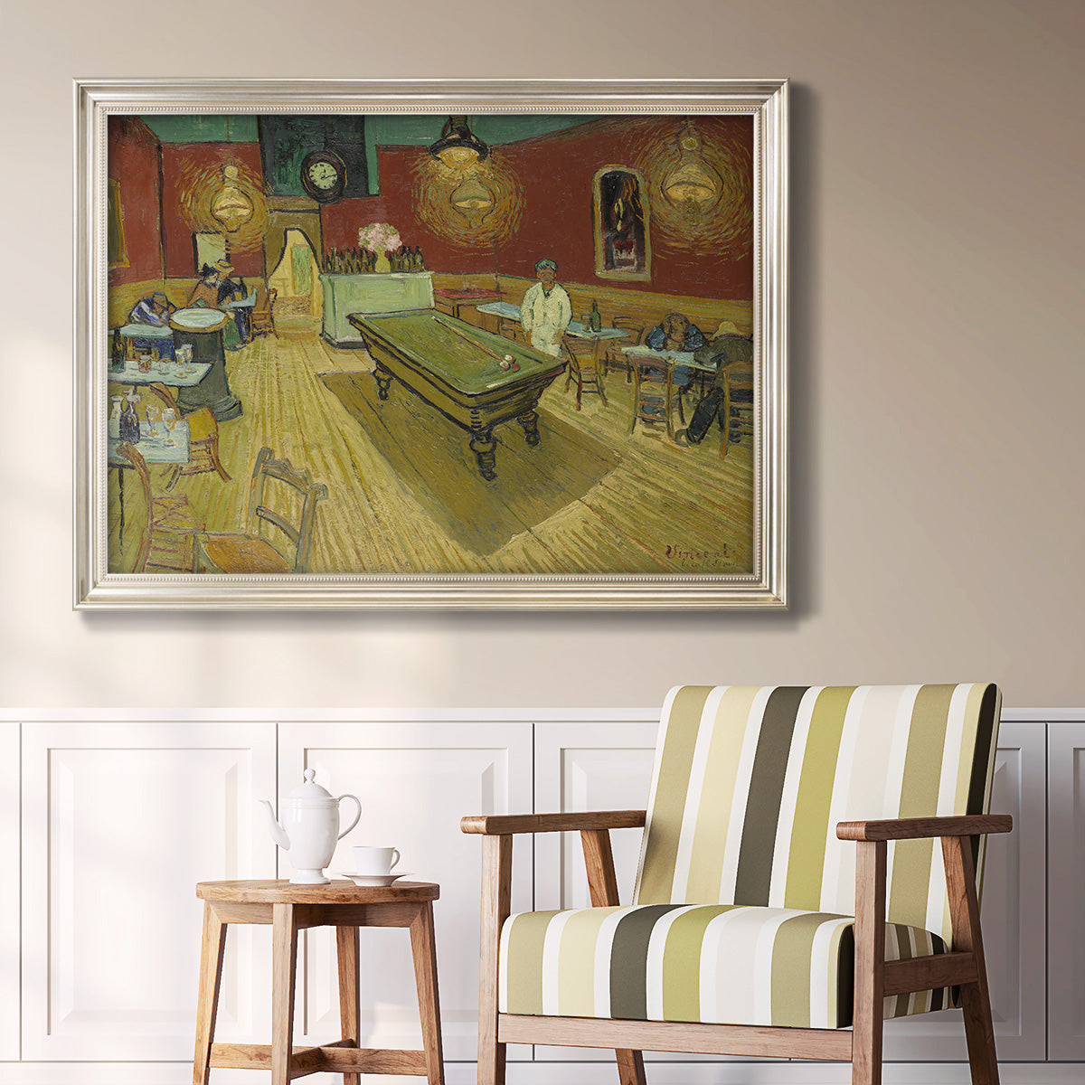 Impressionist interior of a night café by Vincent van Gogh in an ornate champagne frame displayed in a light-toned interior setting.