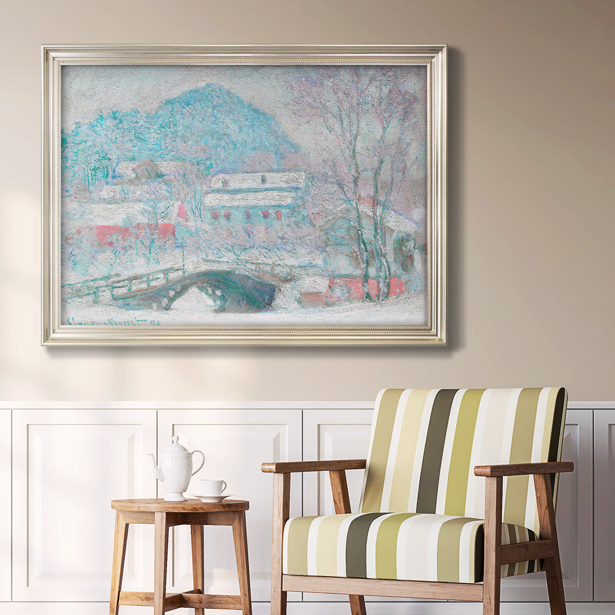 Impressionist coastal village landscape in Norway by Claude Monet in an ornate champagne frame displayed in a light-toned interior setting.