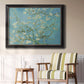 Impressionist flowering almond branch painting by Vincent van Gogh in an ornate black frame with gilded inner detail displayed in a light-toned interior setting.