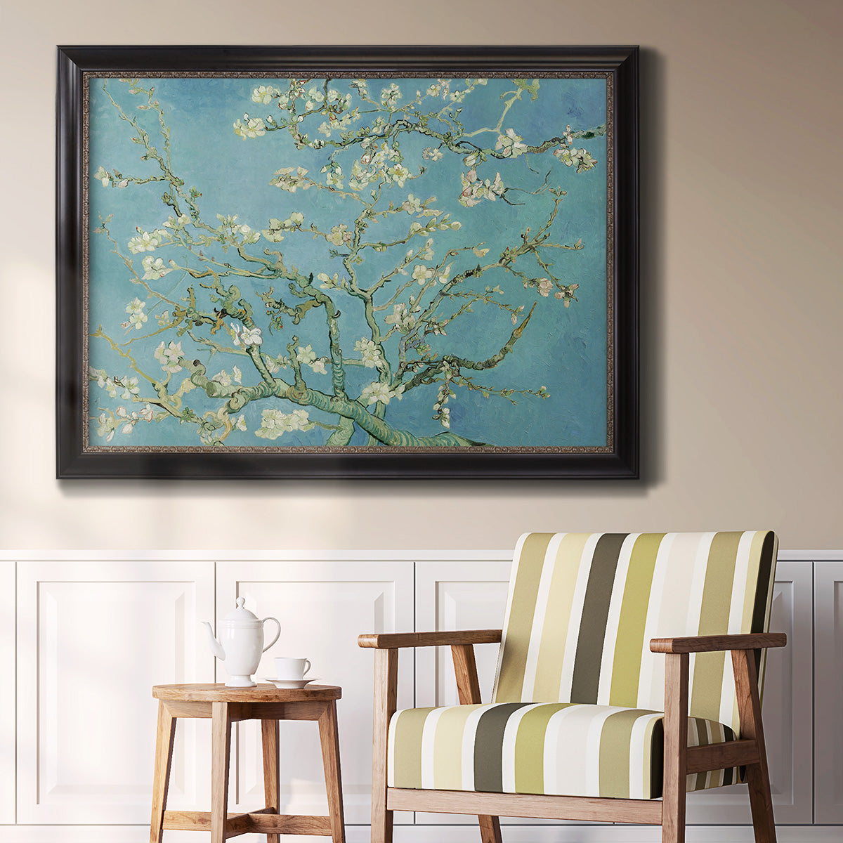 Impressionist flowering almond branch painting by Vincent van Gogh in an ornate black frame with gilded inner detail displayed in a light-toned interior setting.