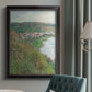 Impressionist landscape view of Vétheuil by Claude Monet in an {frame_style_descriptor} displayed in a neutral interior setting.