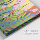Close-up view of wrapped canvas corner featuring bold colorful floral abstraction.