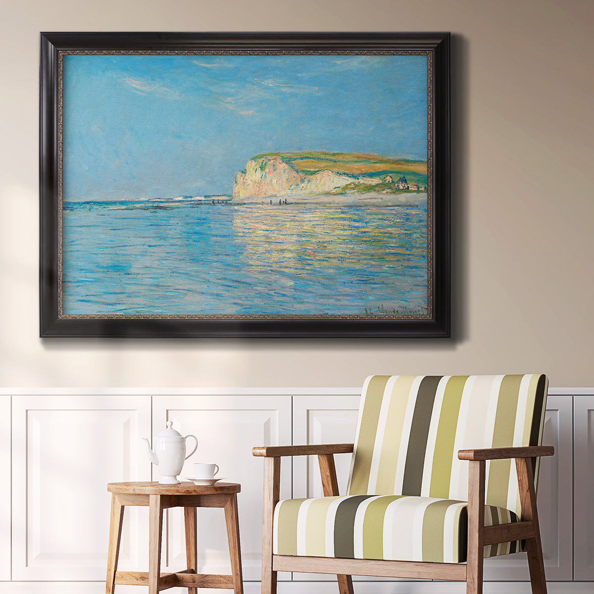 Impressionist coastal low-tide seascape at Pourville by Claude Monet in an ornate black frame with gilded inner detail displayed in a light-toned interior setting.