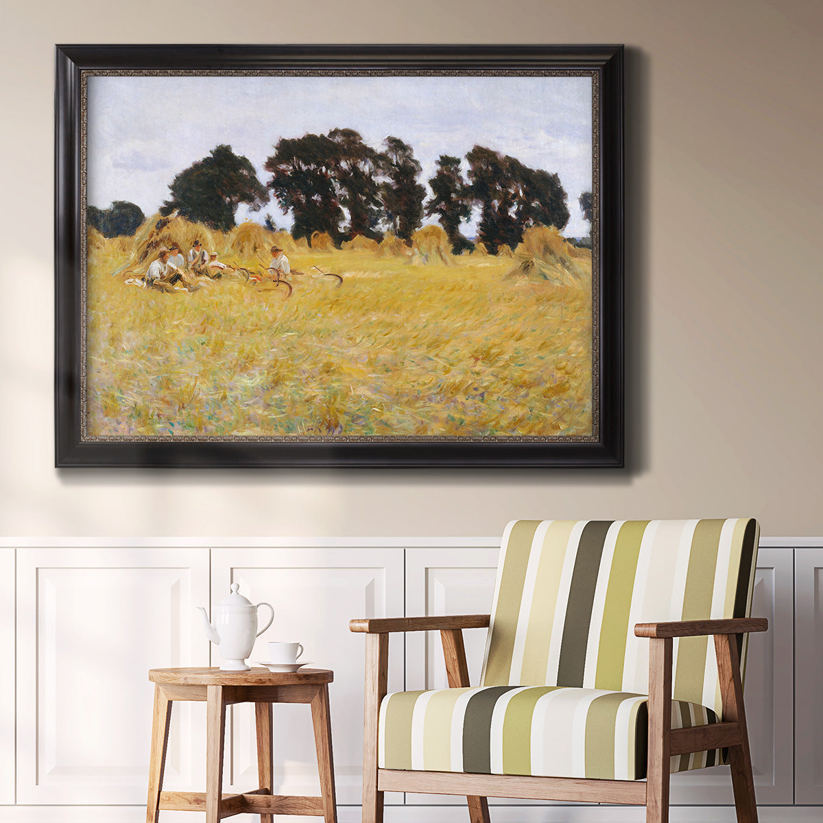 Impressionist rural harvest scene by John Singer Sargent in an ornate black frame with gilded inner detail displayed in a light-toned interior setting.