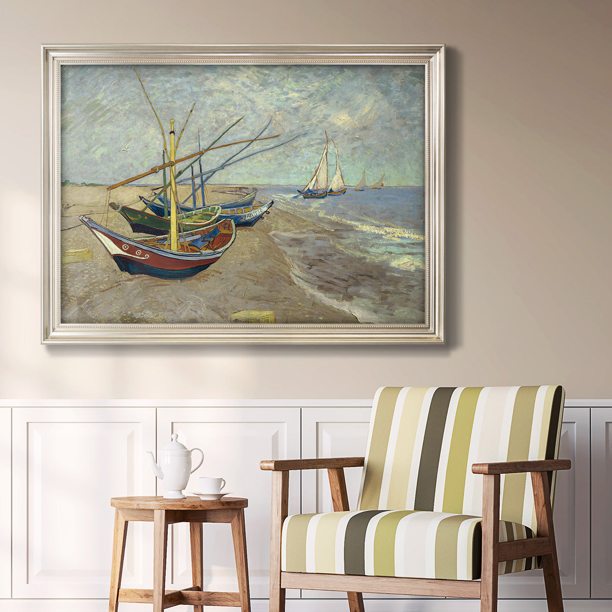 Impressionist coastal fishing boats scene by Vincent van Gogh in an ornate champagne frame displayed in a light-toned interior setting.
