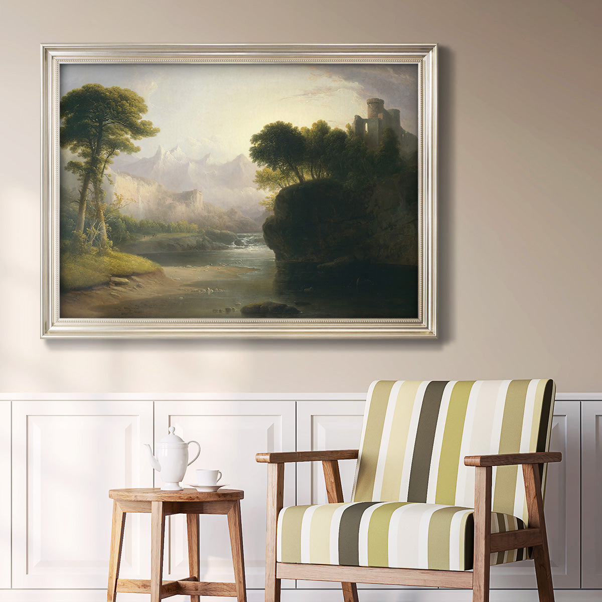 Romantic autumn landscape along the Hudson River by Thomas Doughty in an ornate champagne frame displayed in a light-toned interior setting.