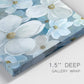 Close-up view of wrapped canvas corner featuring soft white floral abstraction.