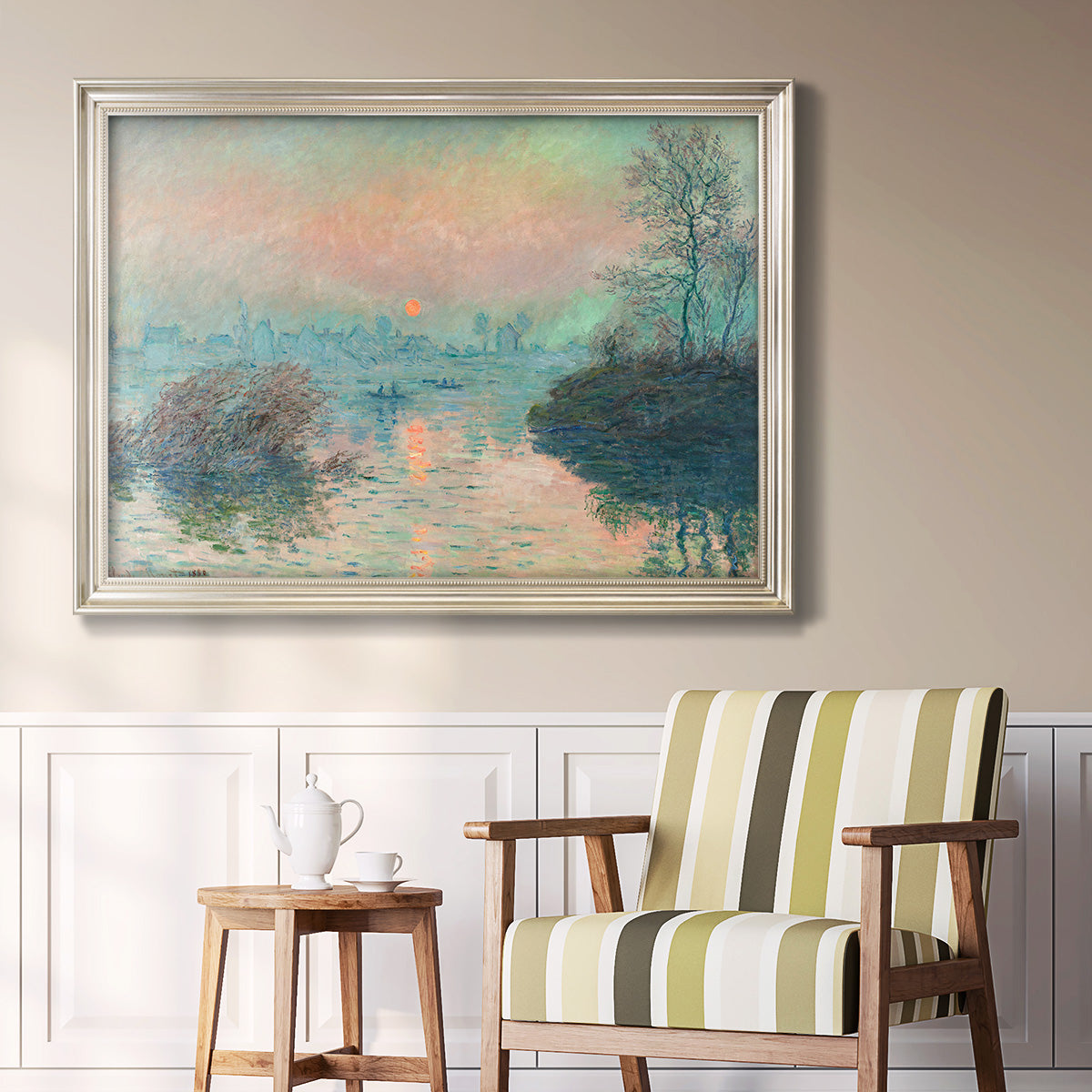 Impressionist winter river sunset scene by Claude Monet in an ornate champagne frame displayed in a light-toned interior setting.