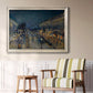 Impressionist nighttime Paris street scene by Camille Pissarro in an ornate champagne frame displayed in a light-toned interior setting.