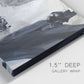 Close-up view of wrapped canvas corner featuring dark abstract atmospheric landscape.