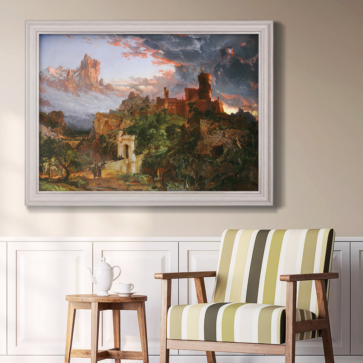 Romantic allegorical landscape painting by Jasper Francis Cropsey in an ornate weathered white frame displayed in a light-toned interior setting.