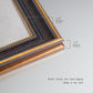 Detail of ornate bronzed mahogany wood frame.