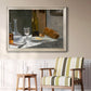 Impressionist still life with wine and bread by Claude Monet in an ornate champagne frame displayed in a light-toned interior setting.