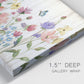 Close-up view of wrapped canvas corner featuring delicate wildflower illustration.