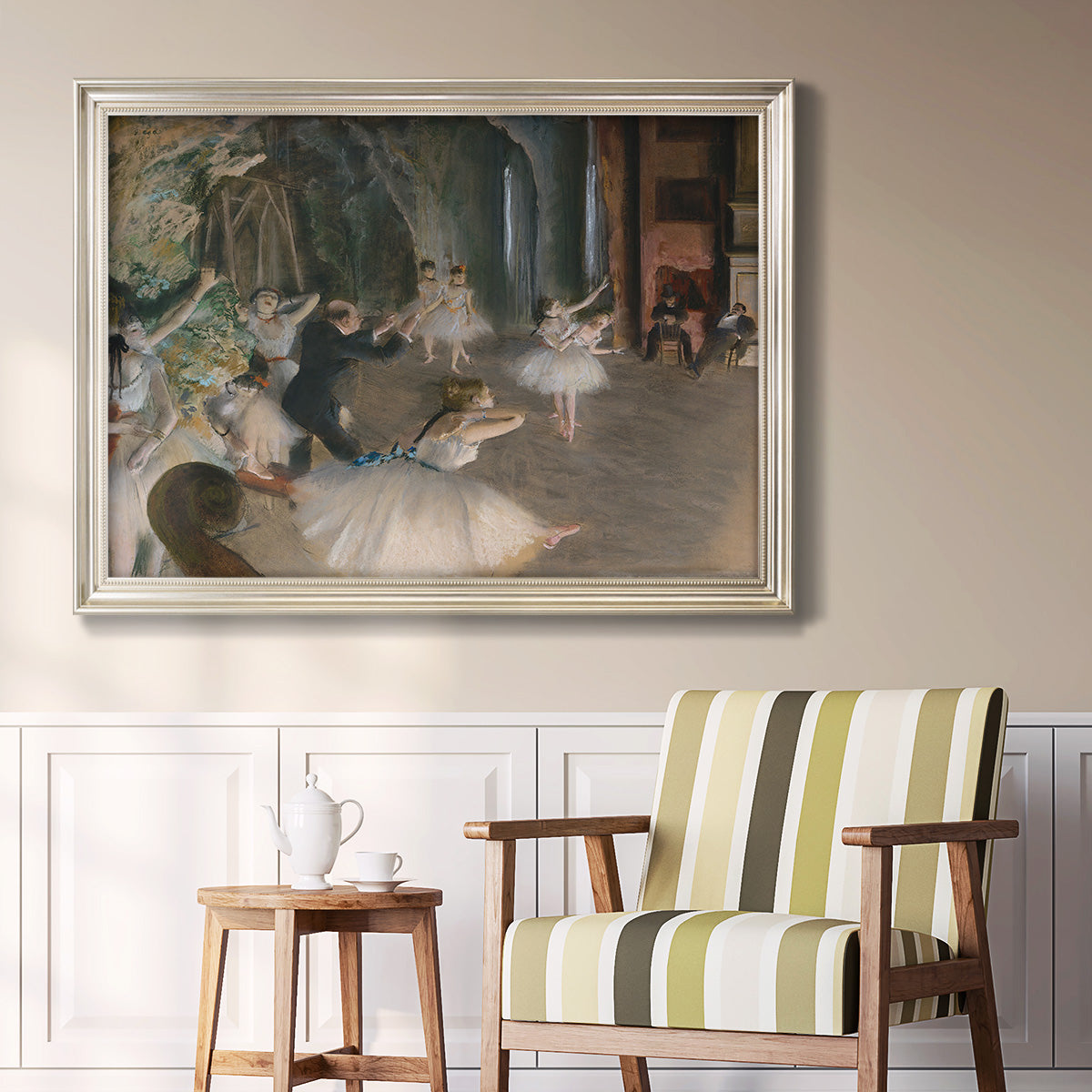 Impressionist backstage ballet scene by Edgar Degas in an ornate champagne frame displayed in a light-toned interior setting.