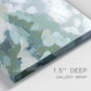 Close-up view of wrapped canvas corner featuring lush green hillside rolling landscape.