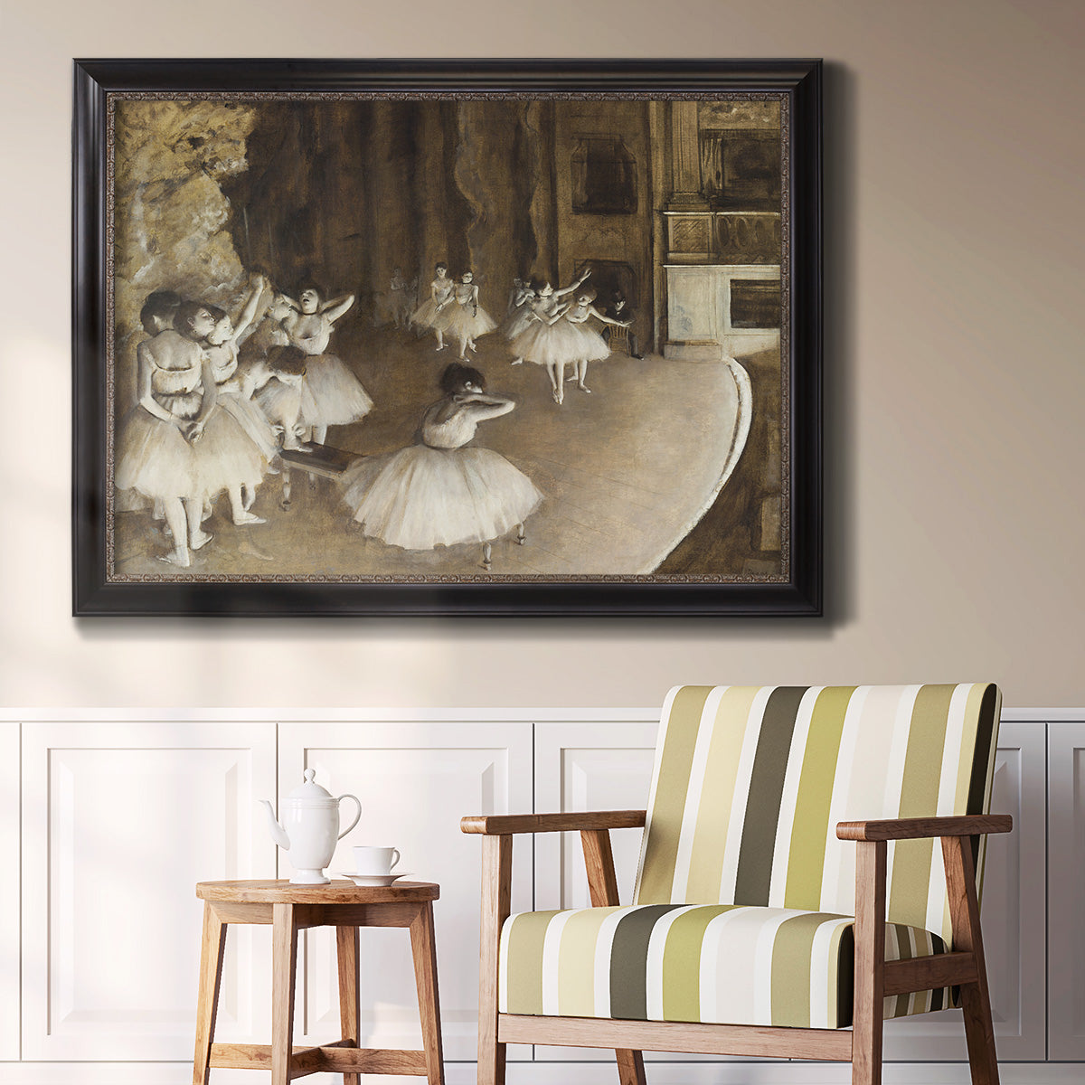 Impressionist ballet rehearsal scene by Edgar Degas in an ornate black frame with gilded inner detail displayed in a light-toned interior setting.