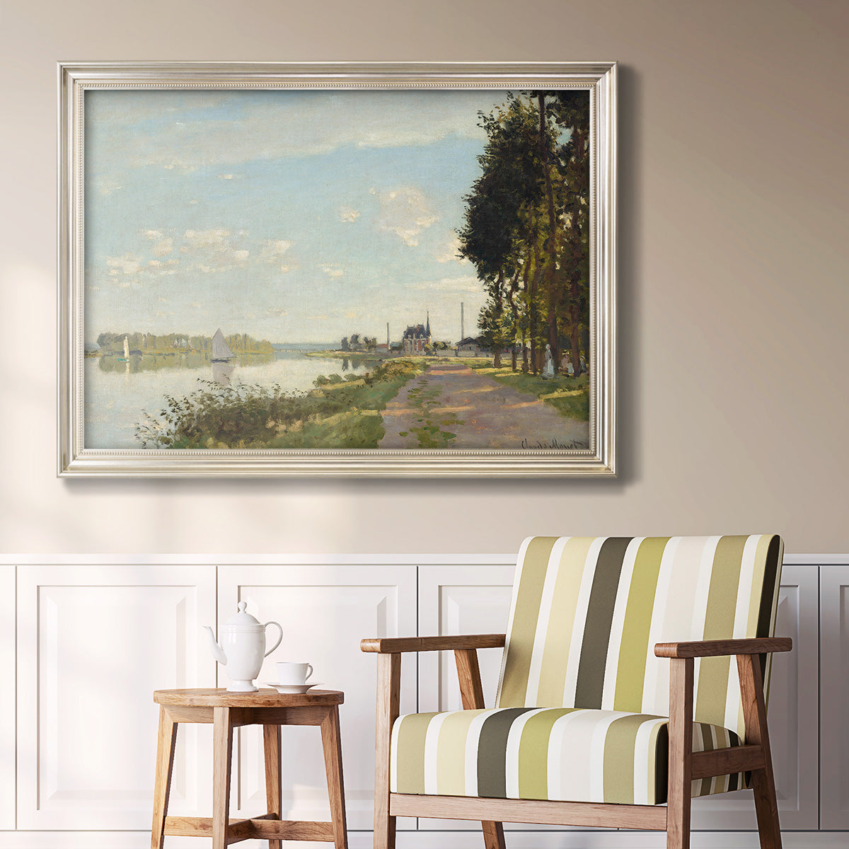 Impressionist river scene with red boats by Claude Monet in an ornate champagne frame displayed in a light-toned interior setting.