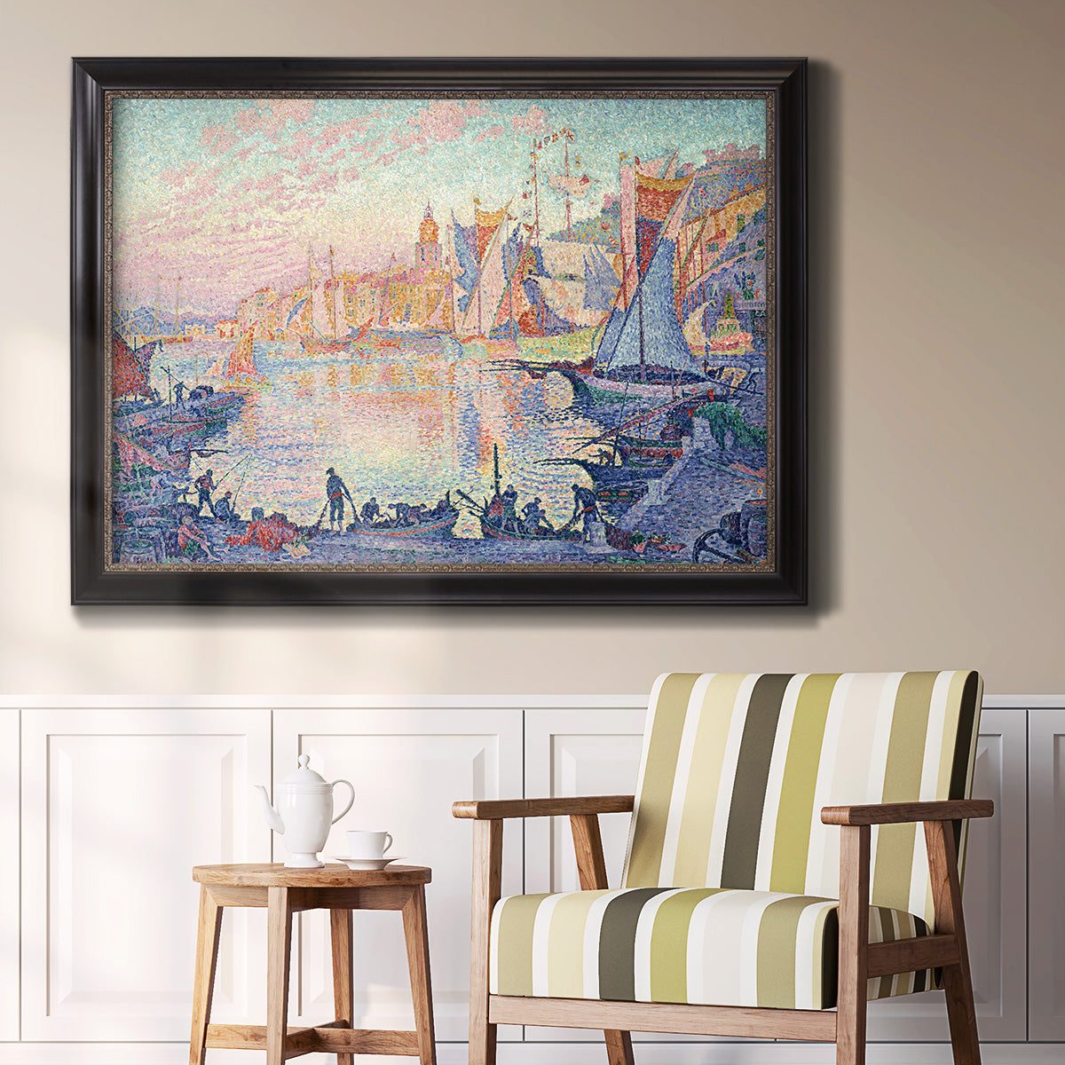 Impressionist Mediterranean harbor painting by Paul Signac in an ornate black frame with gilded inner detail displayed in a light-toned interior setting.
