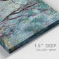 Close-up view of wrapped canvas corner featuring olive trees in sunlit garden.