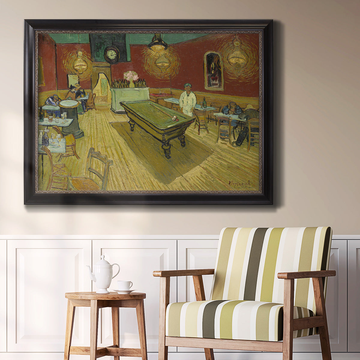 Impressionist interior of a night café by Vincent van Gogh in an ornate black frame with gilded inner detail displayed in a light-toned interior setting.