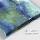Close-up view of wrapped canvas corner featuring flowing blue abstract watercolor.