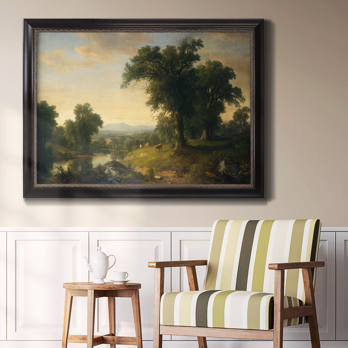 Traditional pastoral landscape painting by Asher Brown Durand in an ornate black frame with gilded inner detail displayed in a light-toned interior setting.