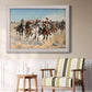 Impressionist western action scene by Frederic Remington in an ornate weathered white frame displayed in a light-toned interior setting.
