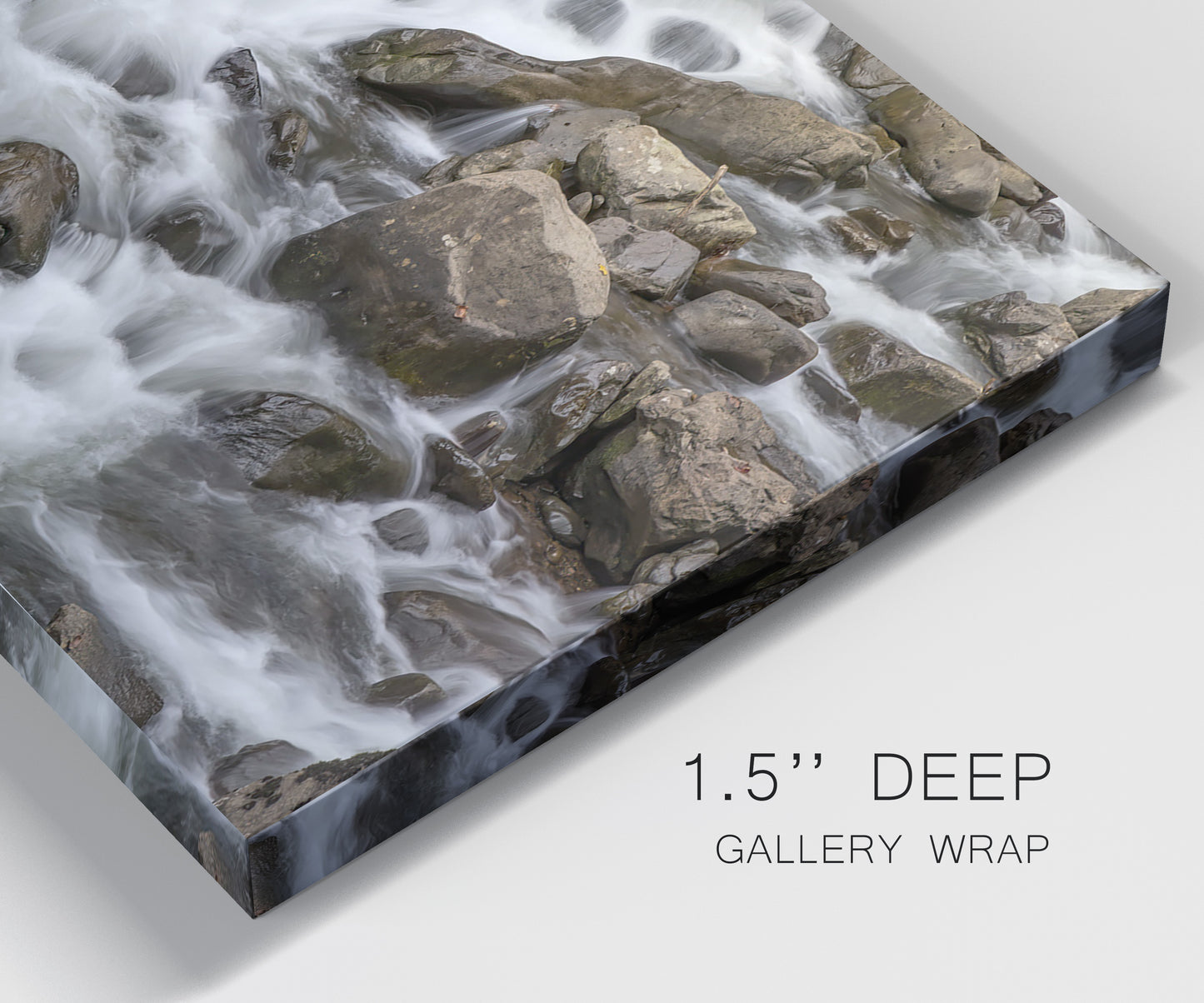 Close-up view of wrapped canvas corner featuring rushing river water over rocks.