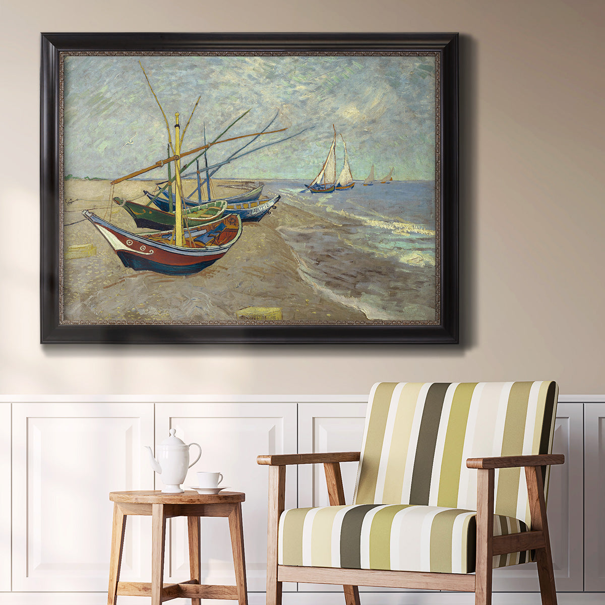 Impressionist coastal fishing boats scene by Vincent van Gogh in an ornate black frame with gilded inner detail displayed in a light-toned interior setting.