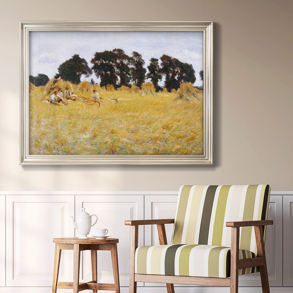 Impressionist rural harvest scene by John Singer Sargent in an ornate champagne frame displayed in a light-toned interior setting.