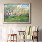 Impressionist spring orchard landscape by Vincent van Gogh in an ornate champagne frame displayed in a light-toned interior setting.