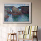 Impressionist rocky seascape by Claude Monet in an ornate weathered white frame displayed in a light-toned interior setting.