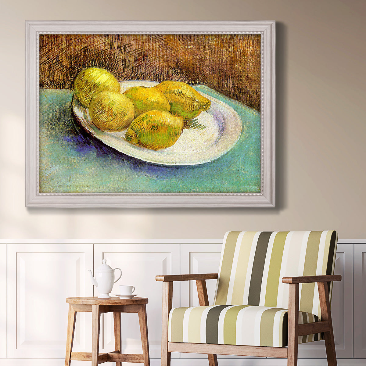 Impressionist still life with lemons by Vincent van Gogh in an ornate weathered white frame displayed in a light-toned interior setting.