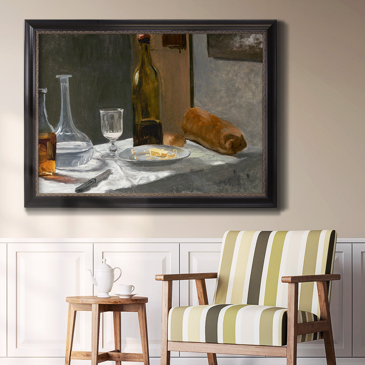 Impressionist still life with wine and bread by Claude Monet in an ornate black frame with gilded inner detail displayed in a light-toned interior setting.