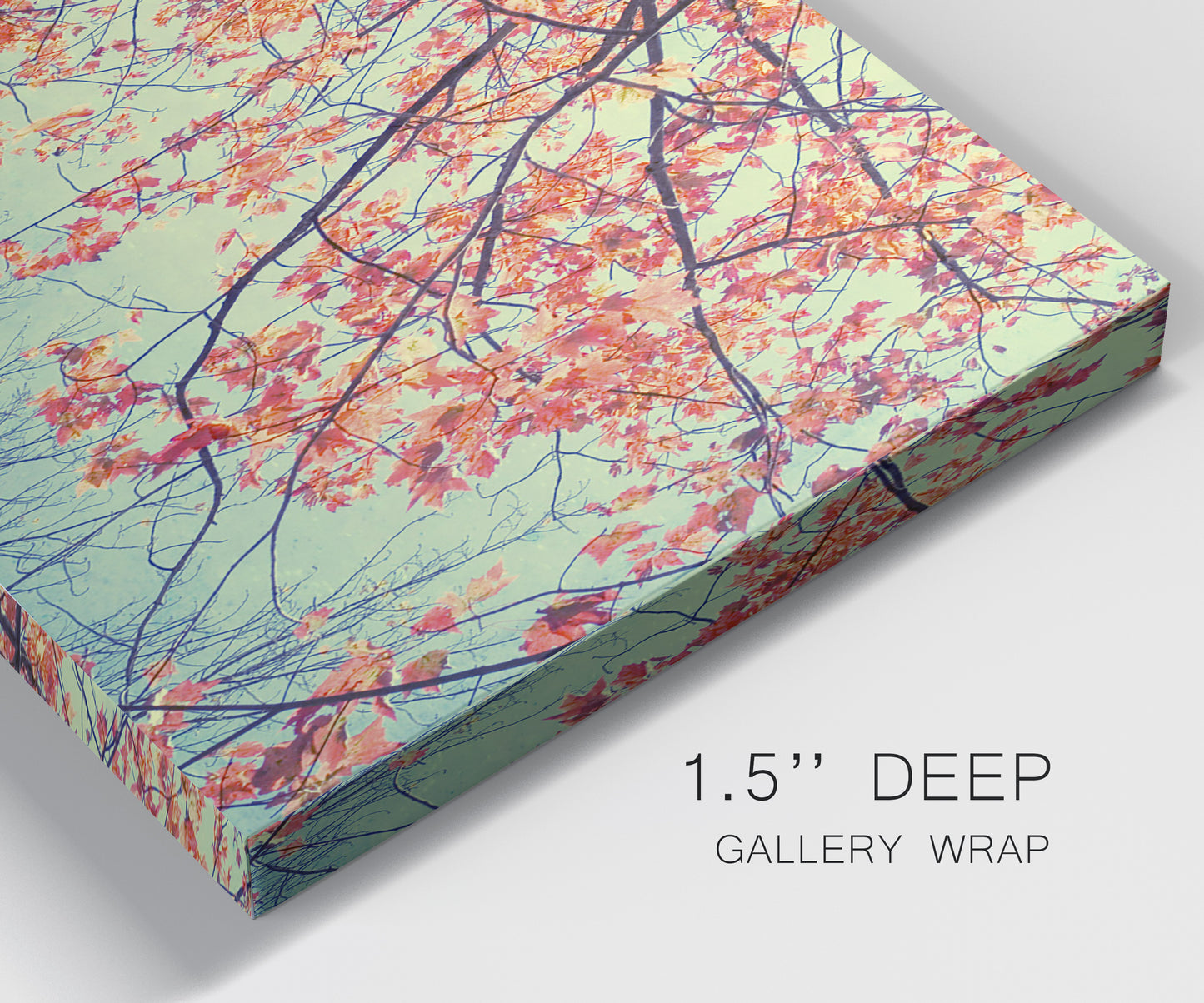 Close-up view of wrapped canvas corner featuring autumn foliage landscape photograph.