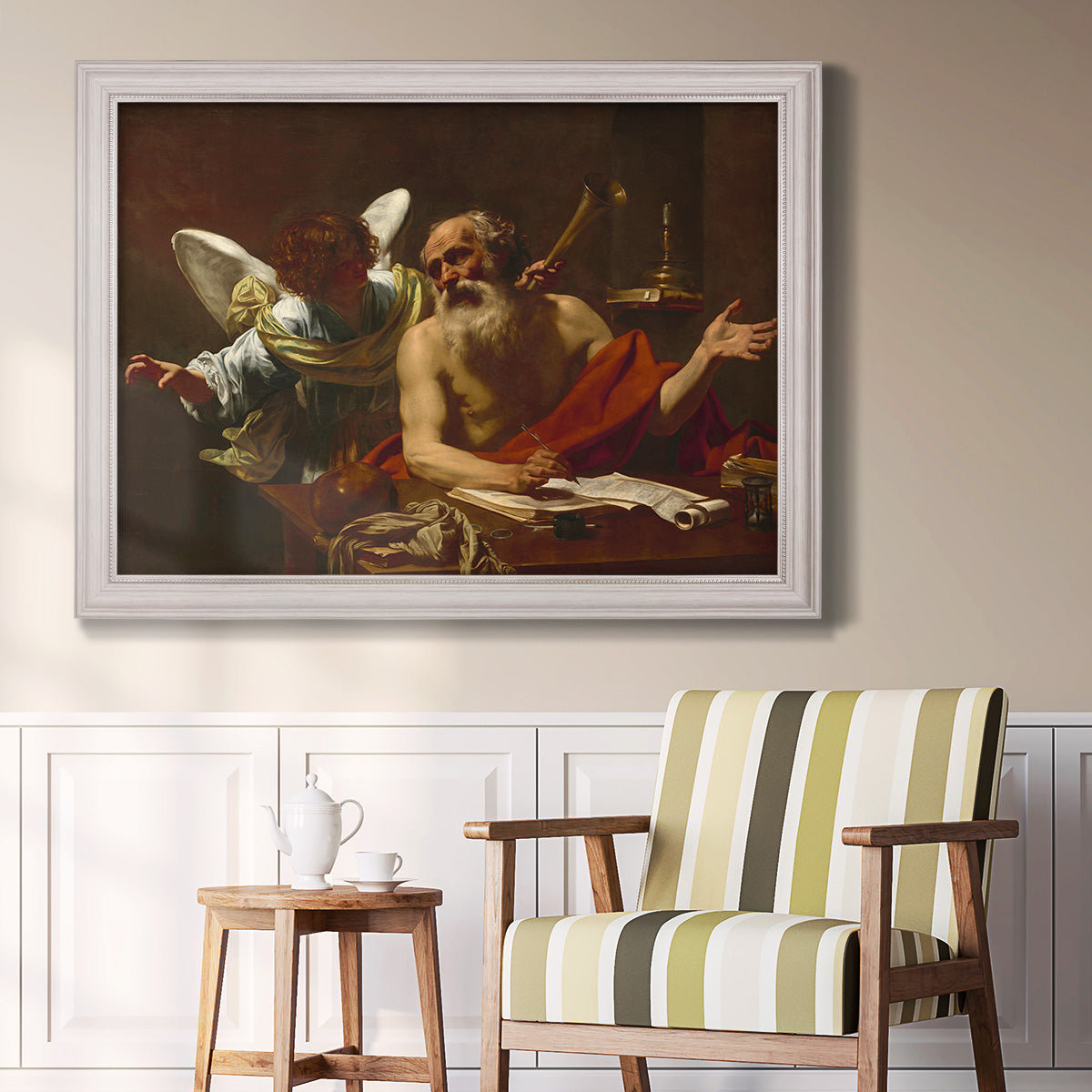 Classical religious painting of Saint Jerome with an angel by Simon Vouet in an ornate weathered white frame displayed in a light-toned interior setting.