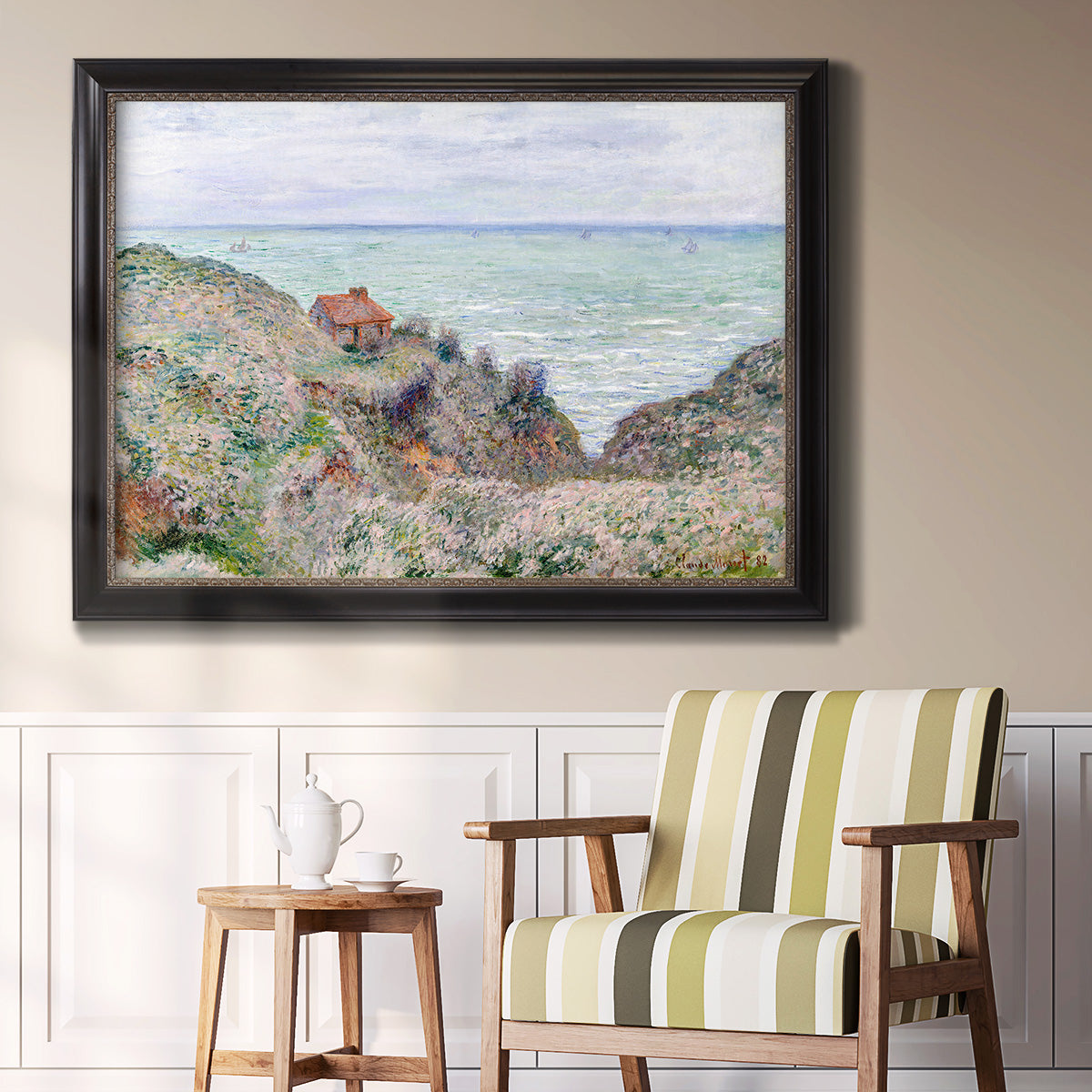 Impressionist coastal watch cabin scene by Claude Monet in an ornate black frame with gilded inner detail displayed in a light-toned interior setting.