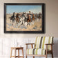 Impressionist western action scene by Frederic Remington in an ornate black frame with gilded inner detail displayed in a light-toned interior setting.