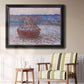 Impressionist single haystack landscape by Claude Monet in an ornate black frame with gilded inner detail displayed in a light-toned interior setting.
