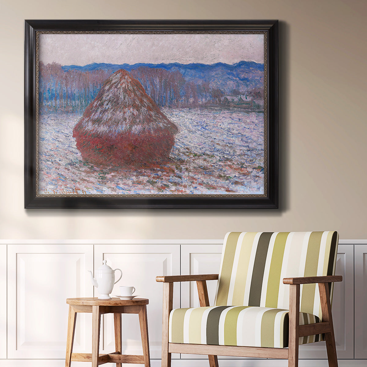Impressionist single haystack landscape by Claude Monet in an ornate black frame with gilded inner detail displayed in a light-toned interior setting.
