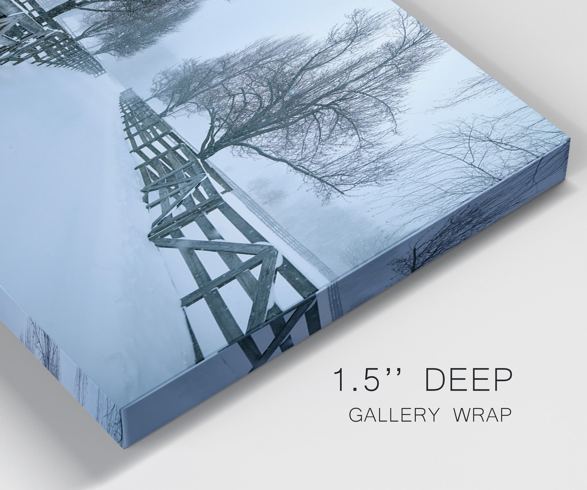 Close-up view of wrapped canvas corner featuring snow covered rural road photograph.